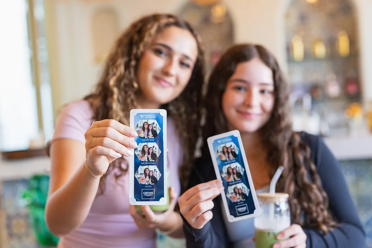 Woman and girl holding up GROHE stickers