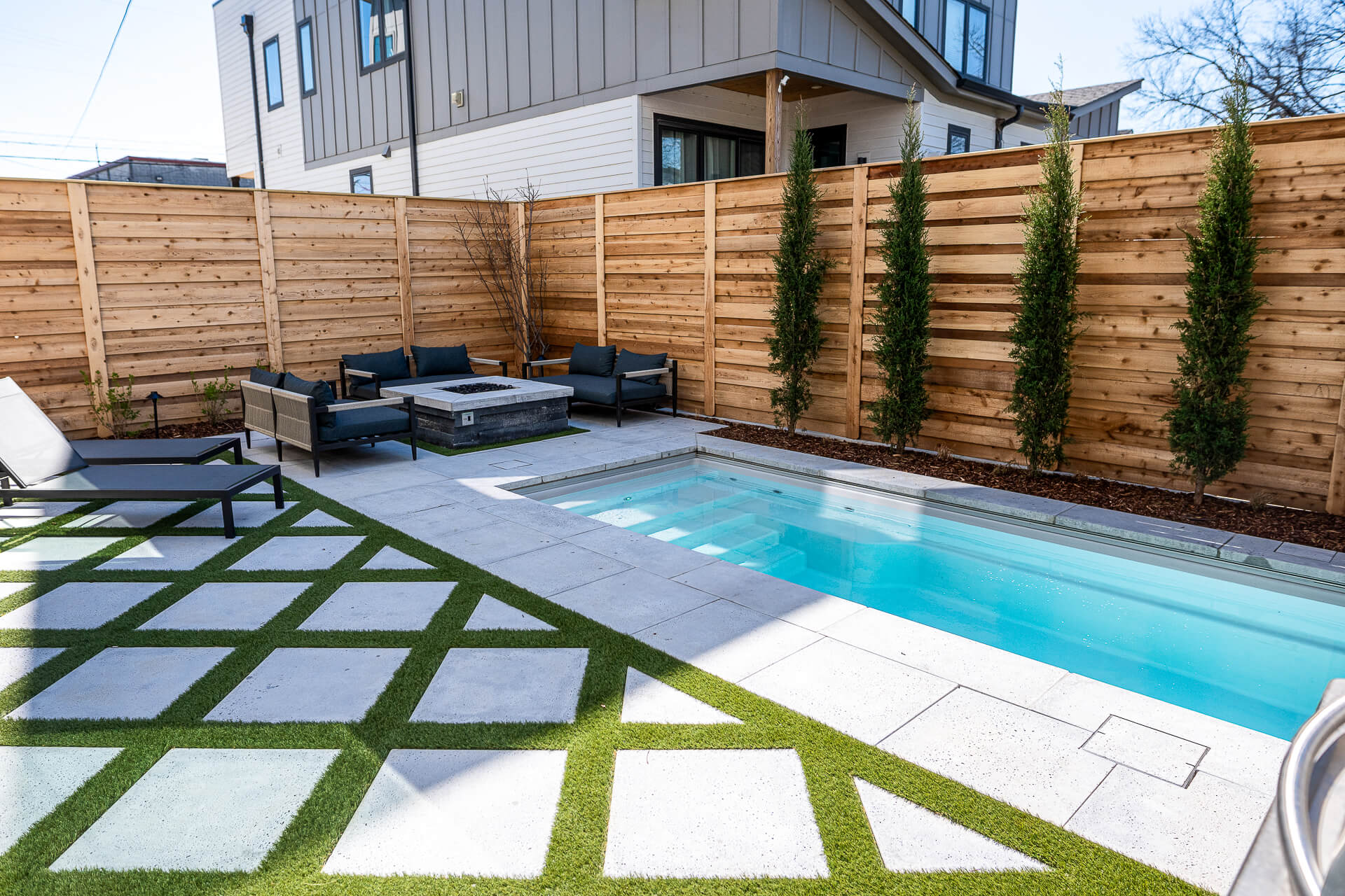 An image of a dip pool in a beautiful back yard setting.