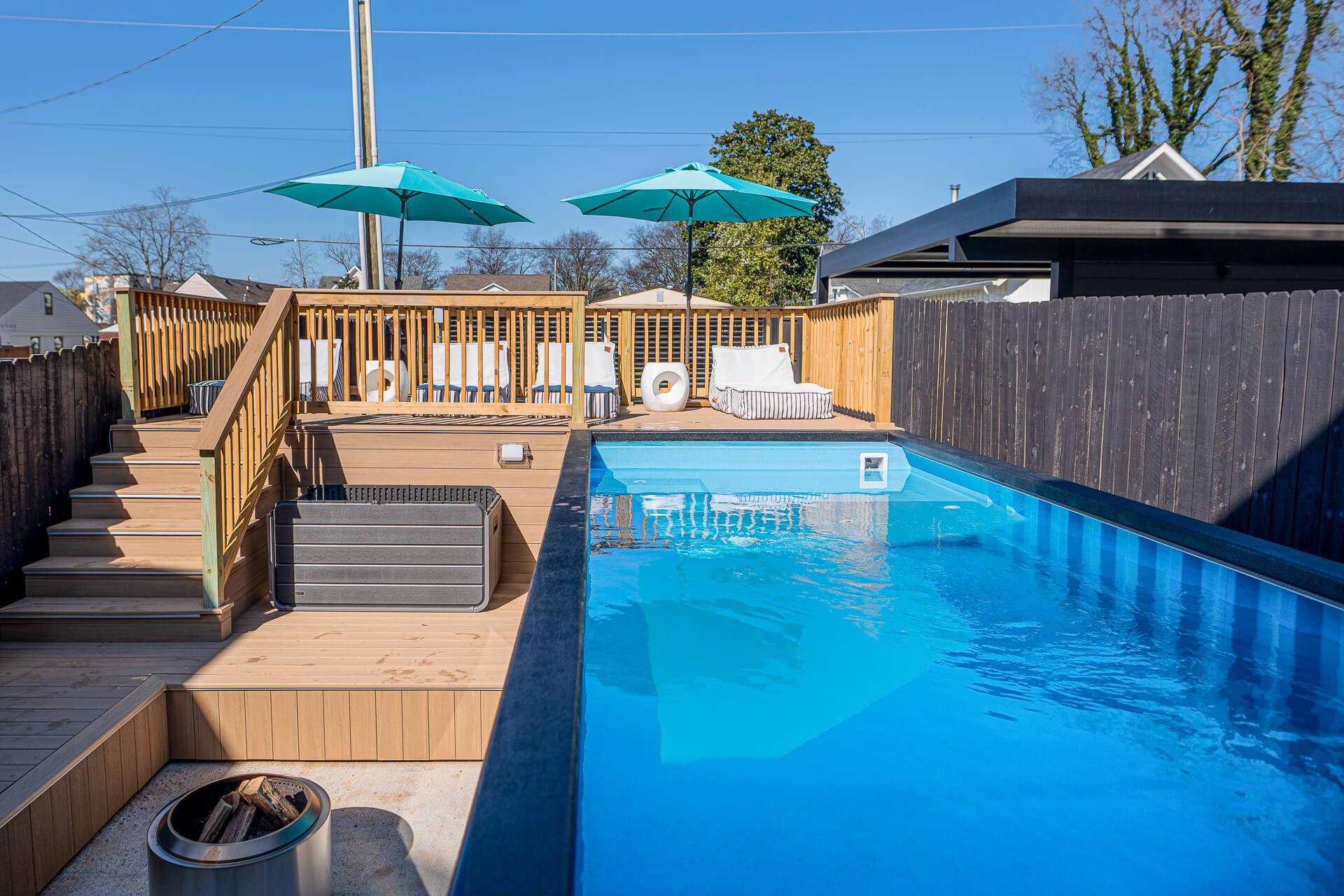 A container pools surrounded by a backyard patio.