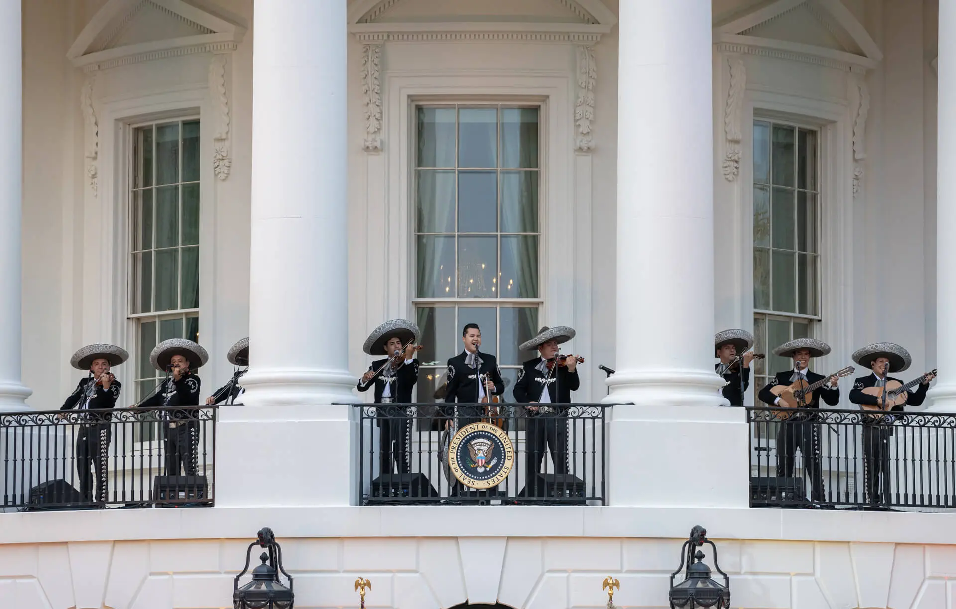 Mariachi band in traditional black outfits and sombreros performing on White House Truman Balcony