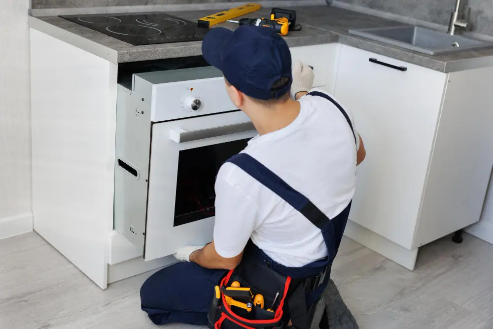 Technician installing a new washer and dryer unit in a Mira Mesa home laundry room.