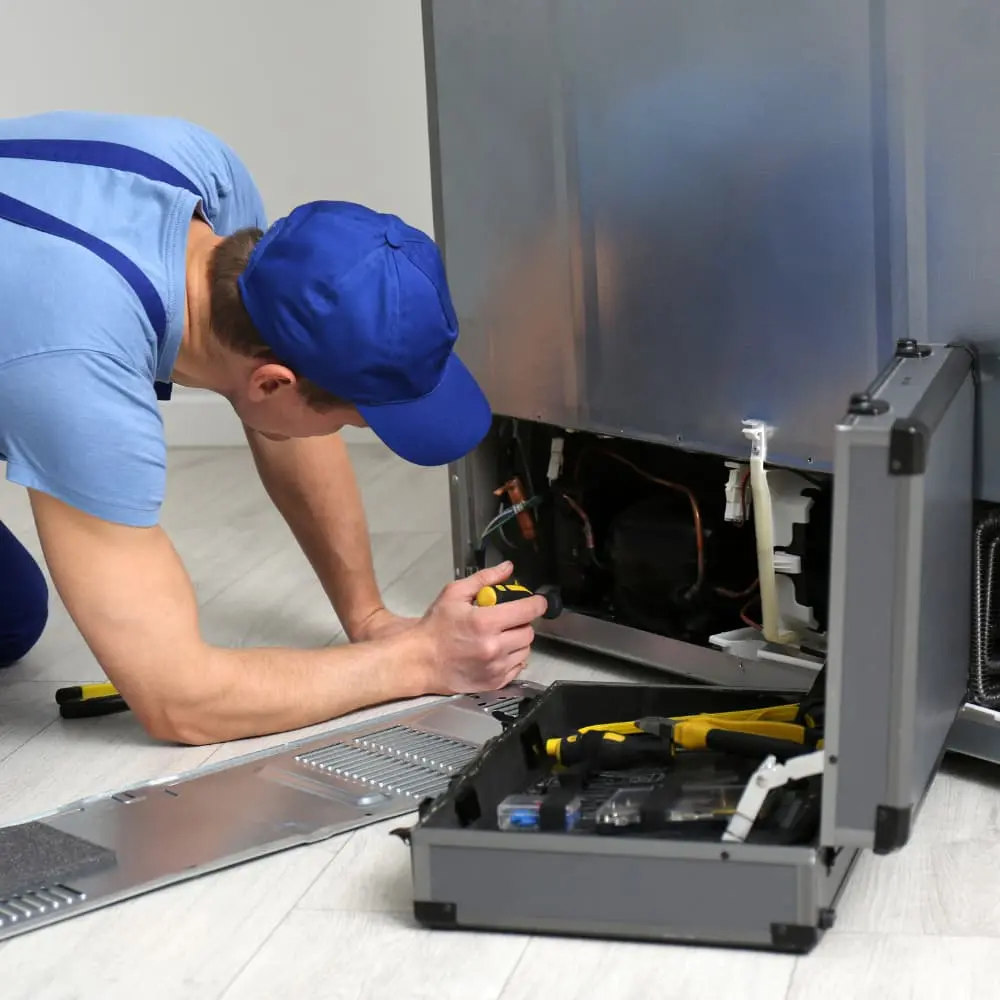Technician performing refrigerator repair in Mira Mesa