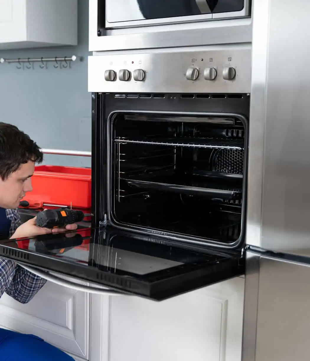 Technician performing oven repair in Mira Mesa