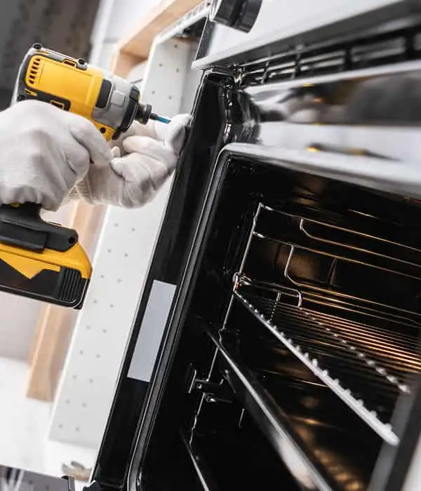 Technician repair a oven door in Mira Mesa
