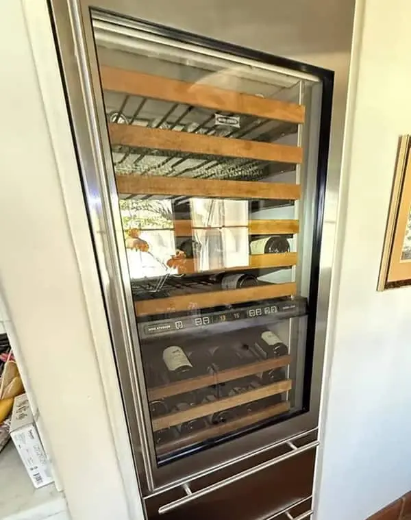 Wine cooler repair on a built-in dual-zone unit with wooden shelves in a Mira Mesa kitchen.