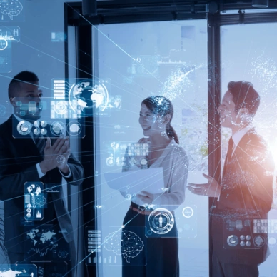 Three business professionals discussing with digital technology holograms around them in an office setting.