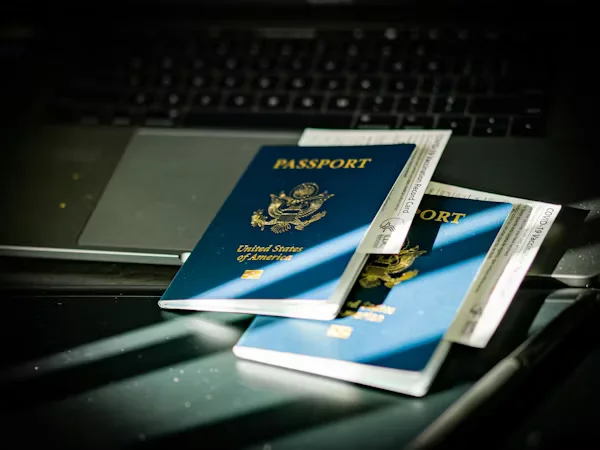 U.S. passports with boarding passes on laptop Beyond Border