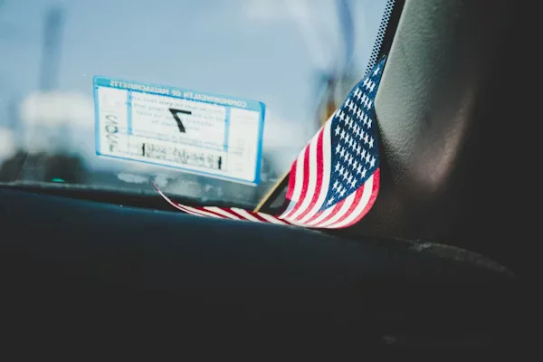 American flag on car dashboard by window Beyond Border