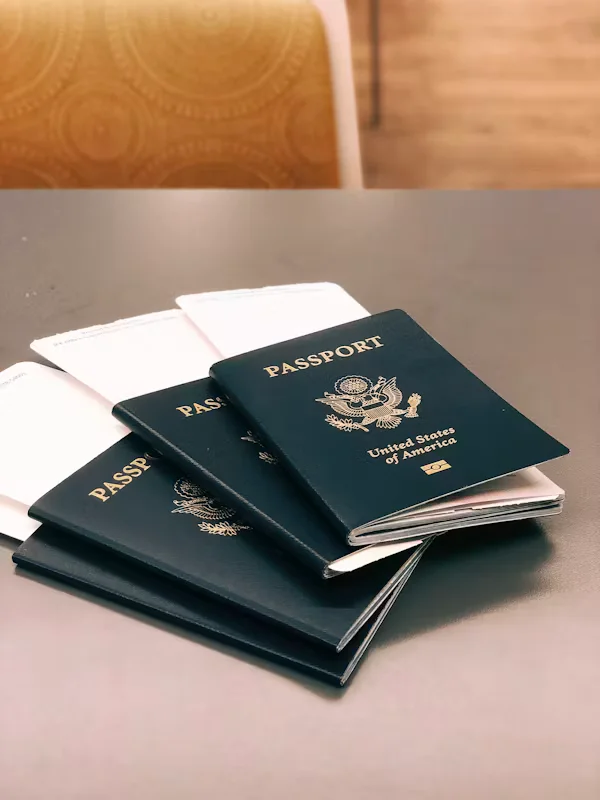 Stack of U.S. passports with boarding passes Beyond Border