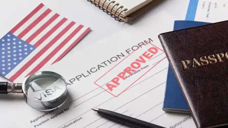 Approved visa application with passport and U.S. flag Beyond Border