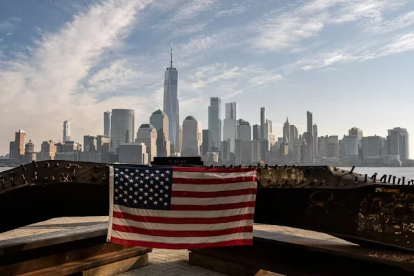 New York skyline with U.S. flag in foreground Beyond Border