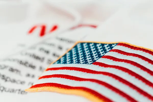 Embroidered American flag patch on fabric Beyond Border