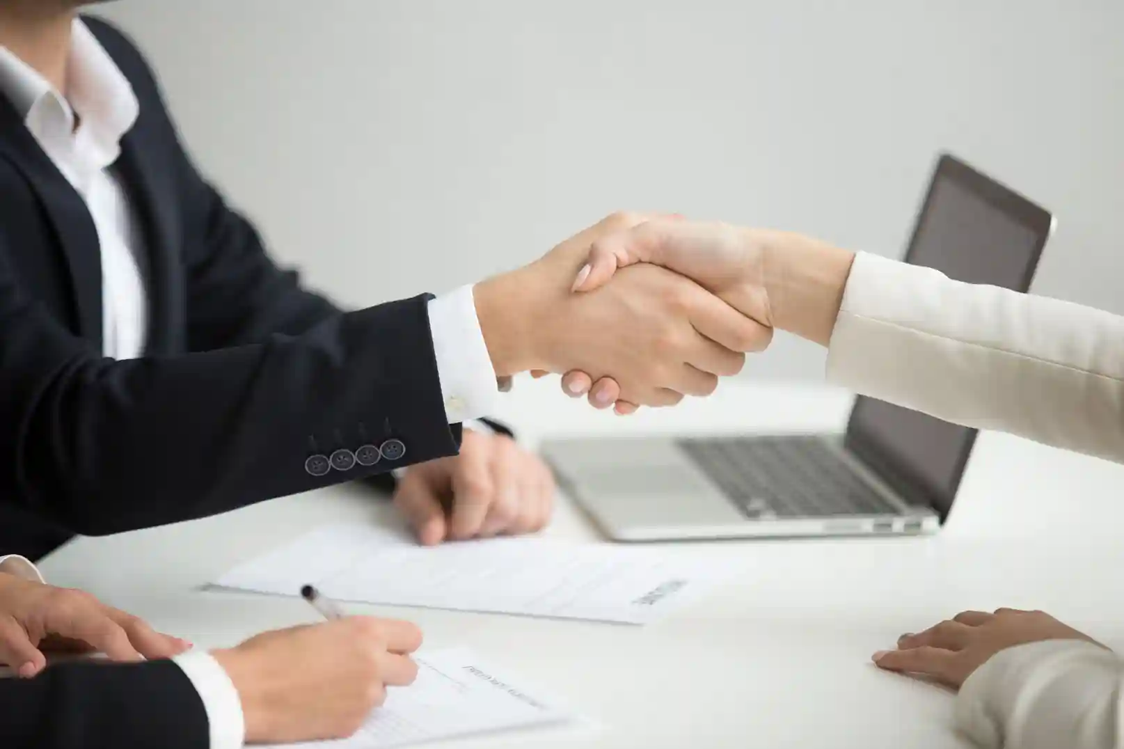 A professional handshake during a business meeting. Beyond Border.