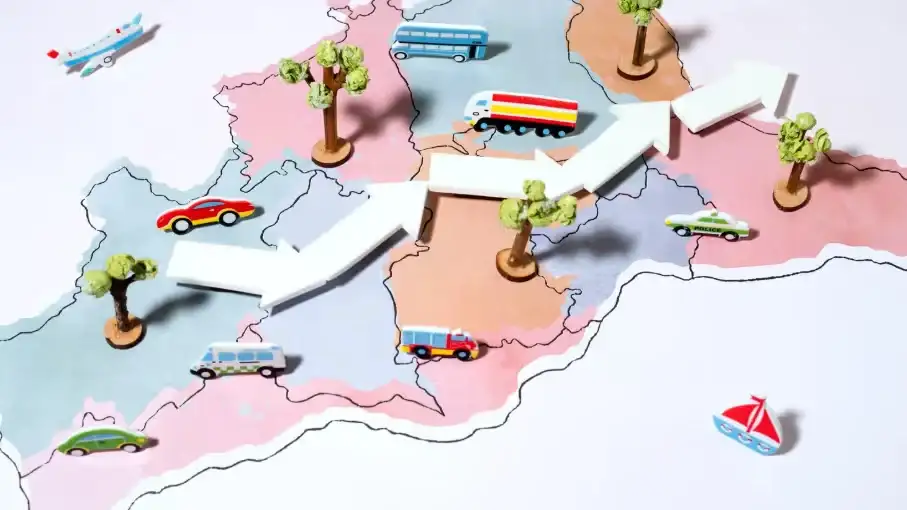 A playful map with miniature vehicles and arrows showing movement. Beyond Border.