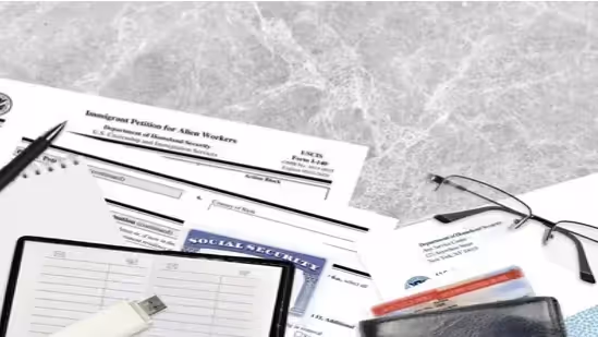 Immigration forms, Social Security card, and documents on desk. Beyond Border.