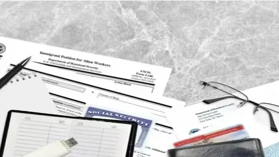 Immigration forms, Social Security card, and documents on desk. Beyond Border.