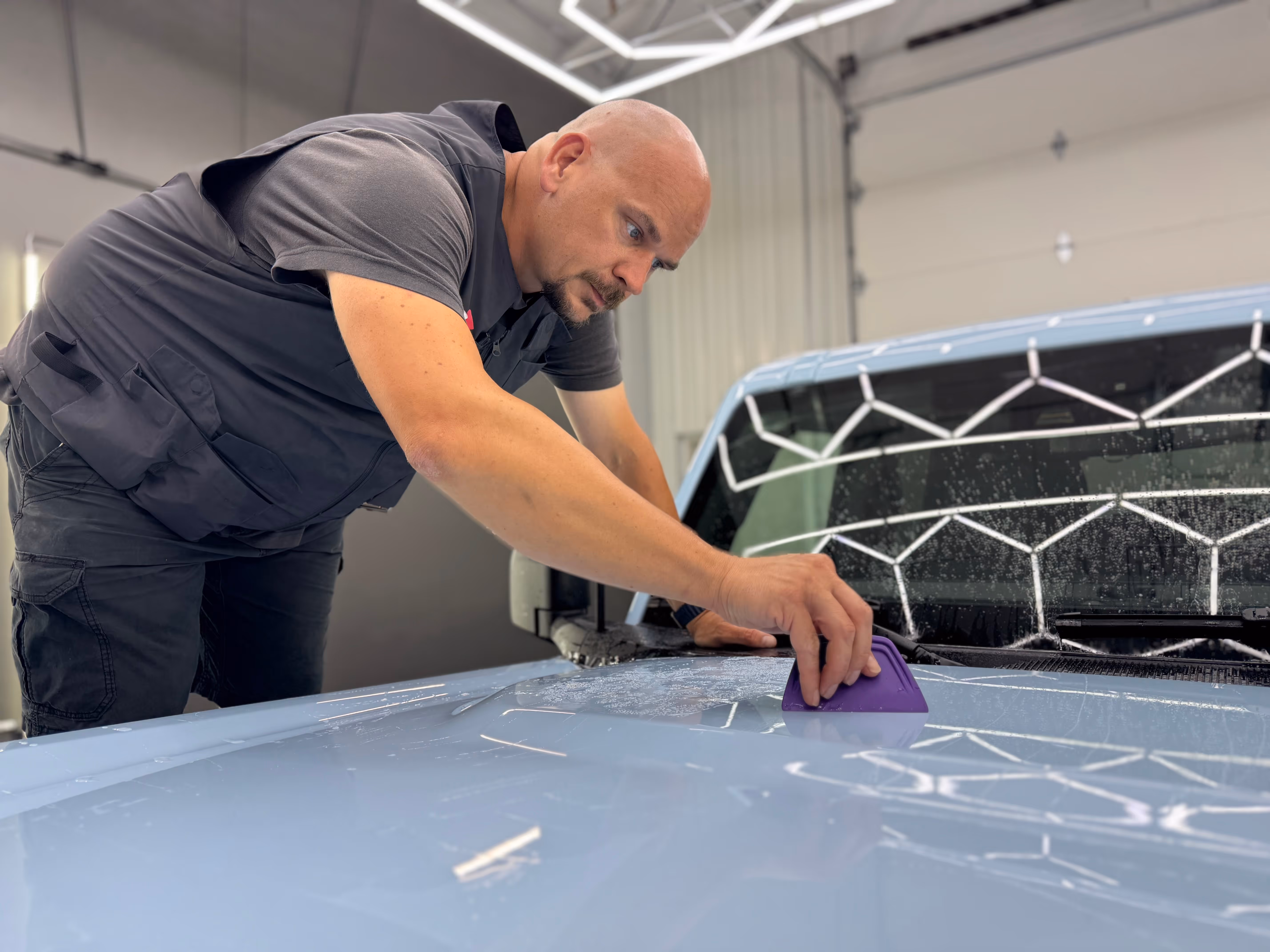 PPF application in progress on the hood of a vehicle in Chattanooga Auto Film shop