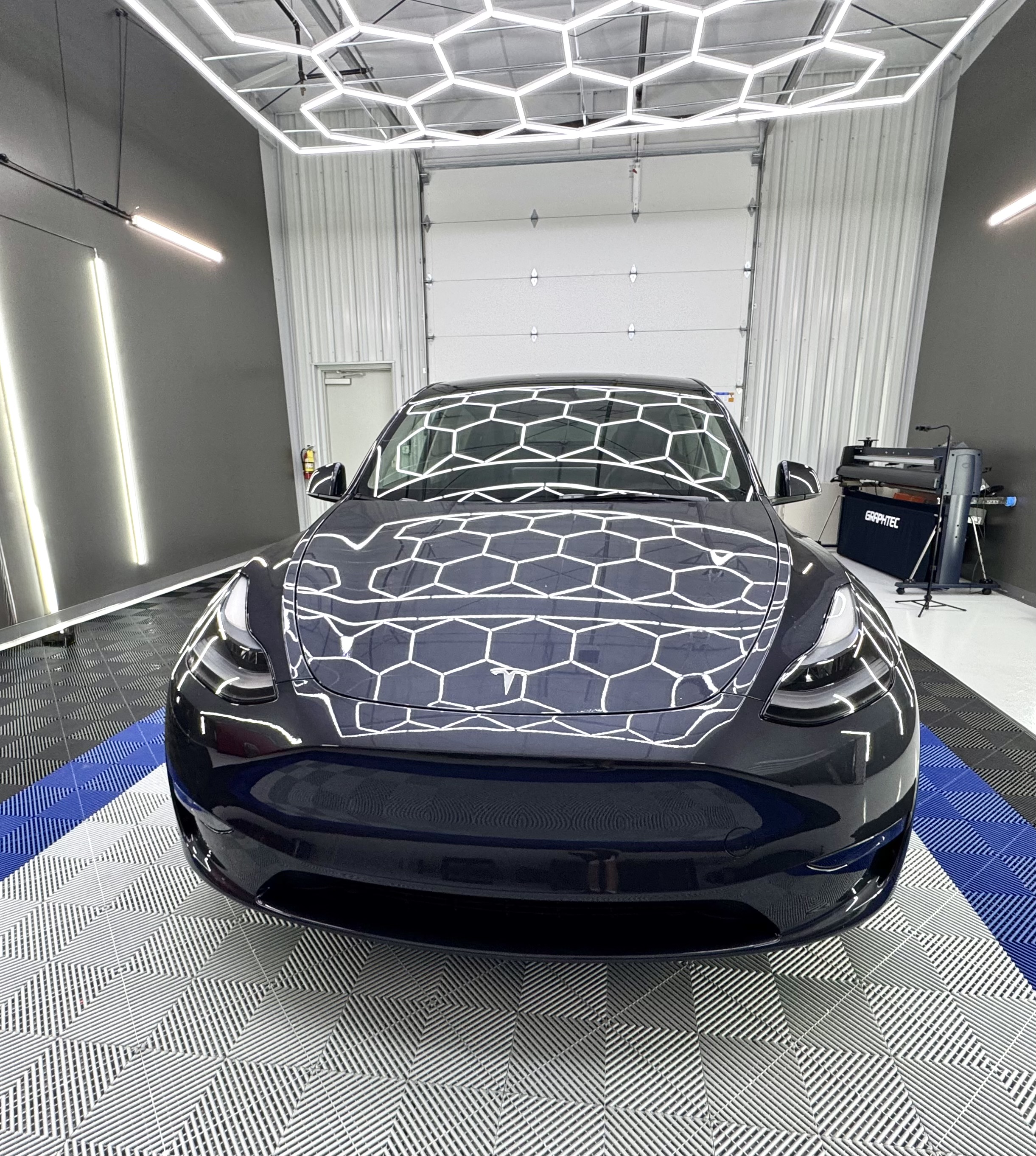 Blue Tesla Model Y on Chattanooga Auto Film Pros shop floor