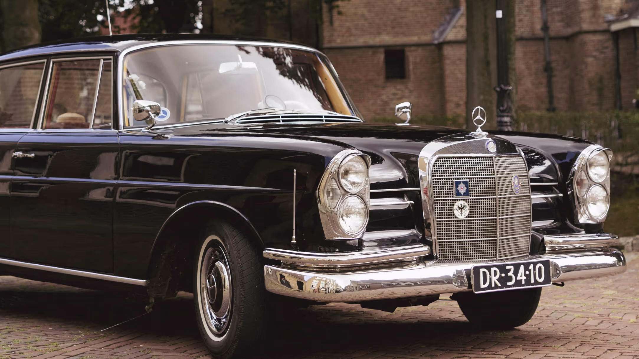 Klassieke borgo Mercedes trouwauto op oude straatbestrating geparkeerd