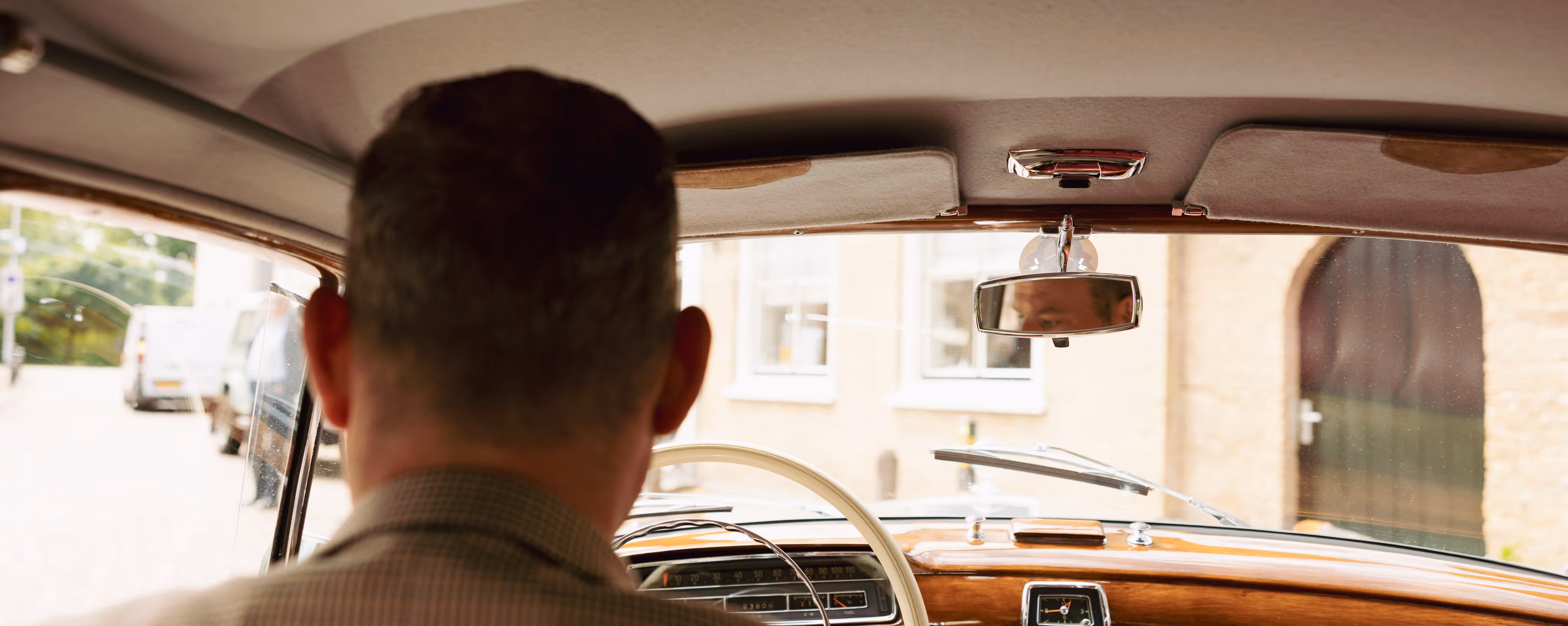 Borgo klassieke trouwauto met bestuurder van achteren gezien, vintage interieur