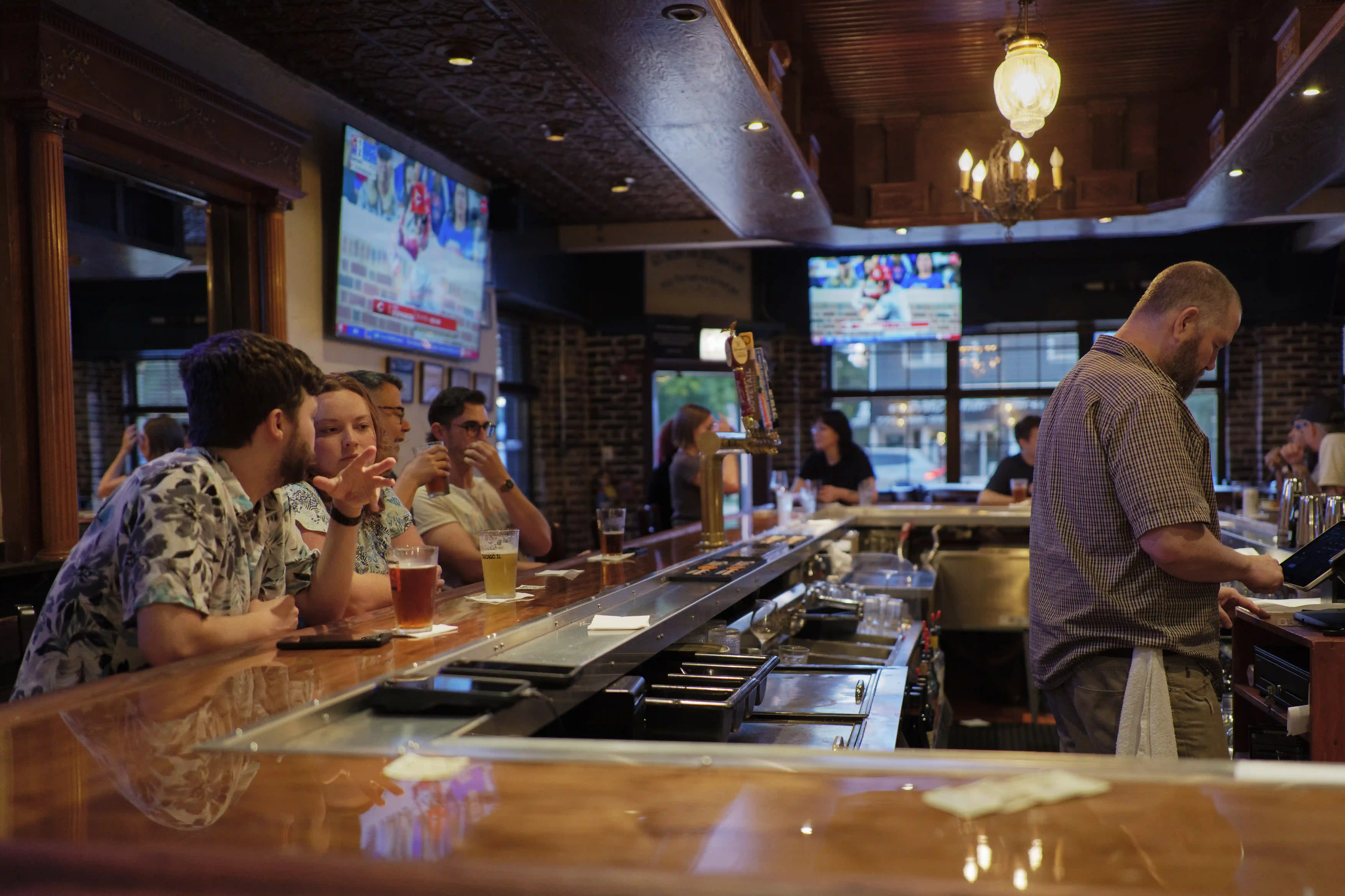Image of patrons and bartender