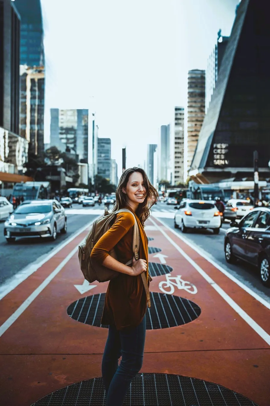 A girl standing on a busy road.