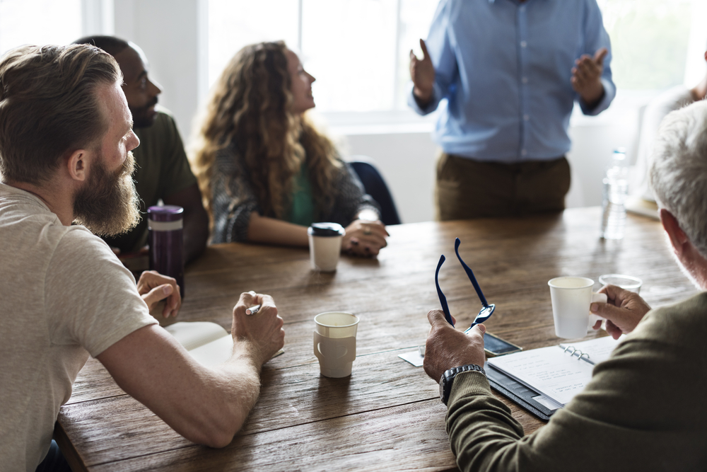 A business owner meeting with his employees