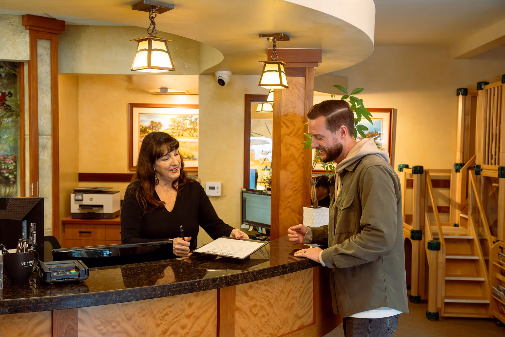 A man and a woman standing in a hotel lobby.