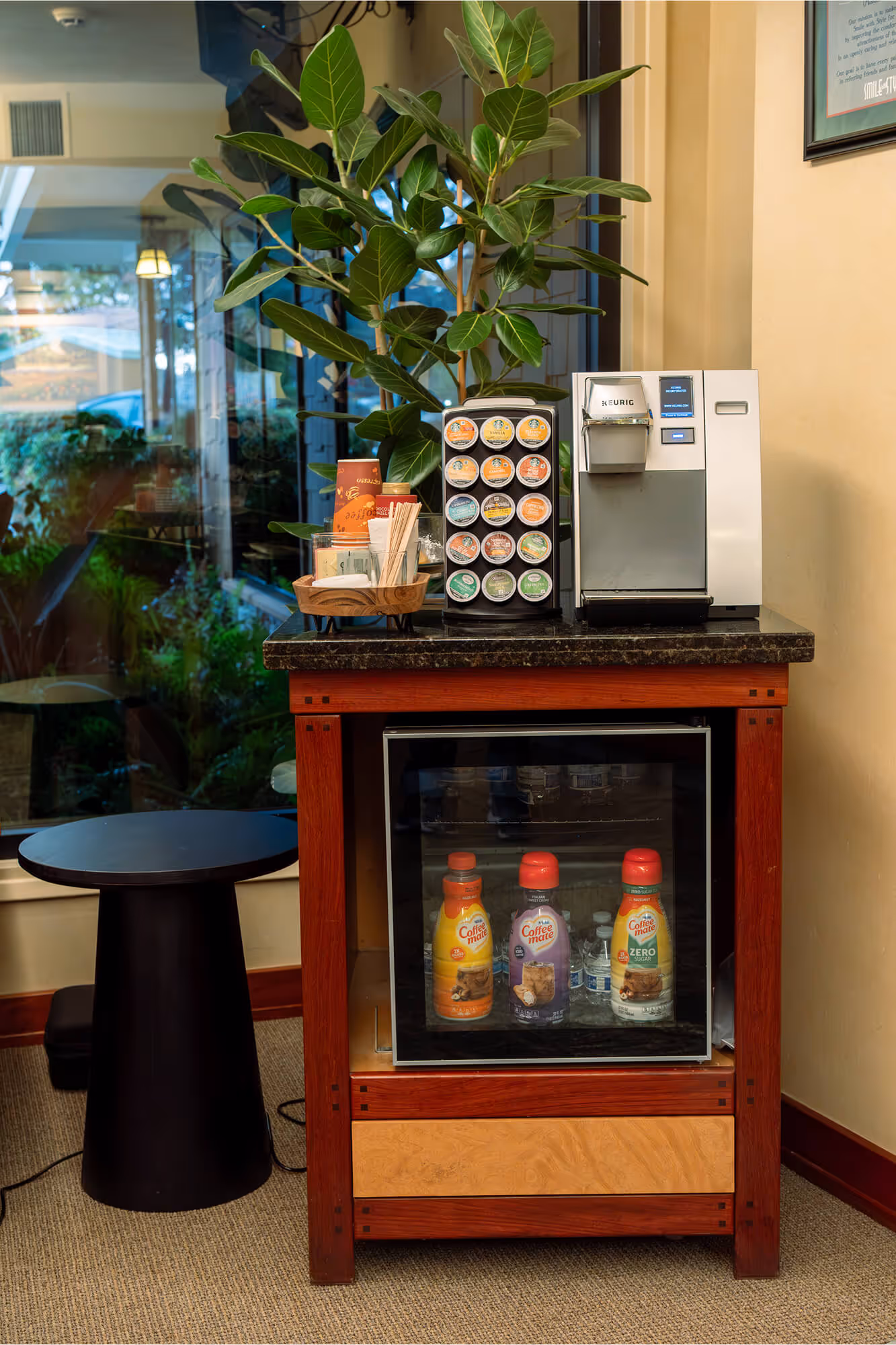 A coffee machine sitting on top of a wooden table.