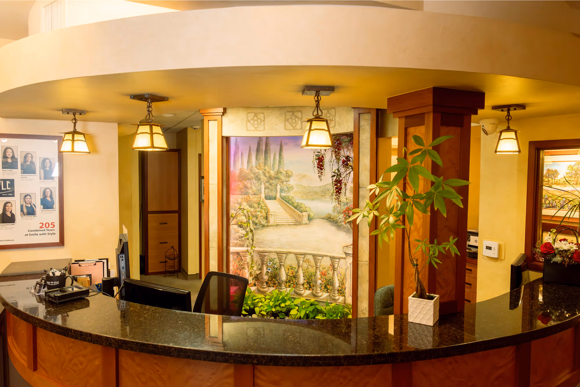 A counter in a hotel with a painting on the wall.