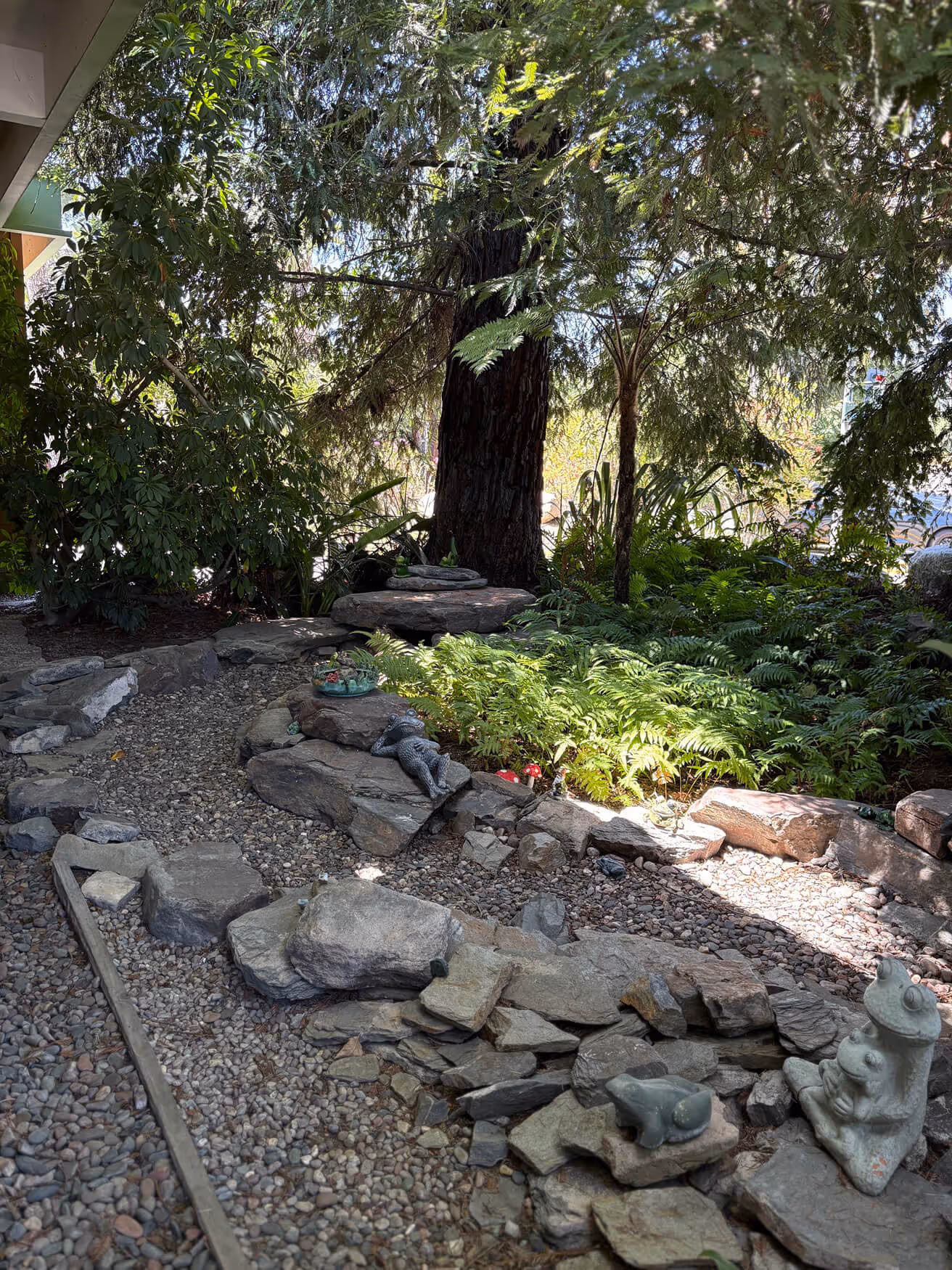 There is a rock path in the middle of the yard.