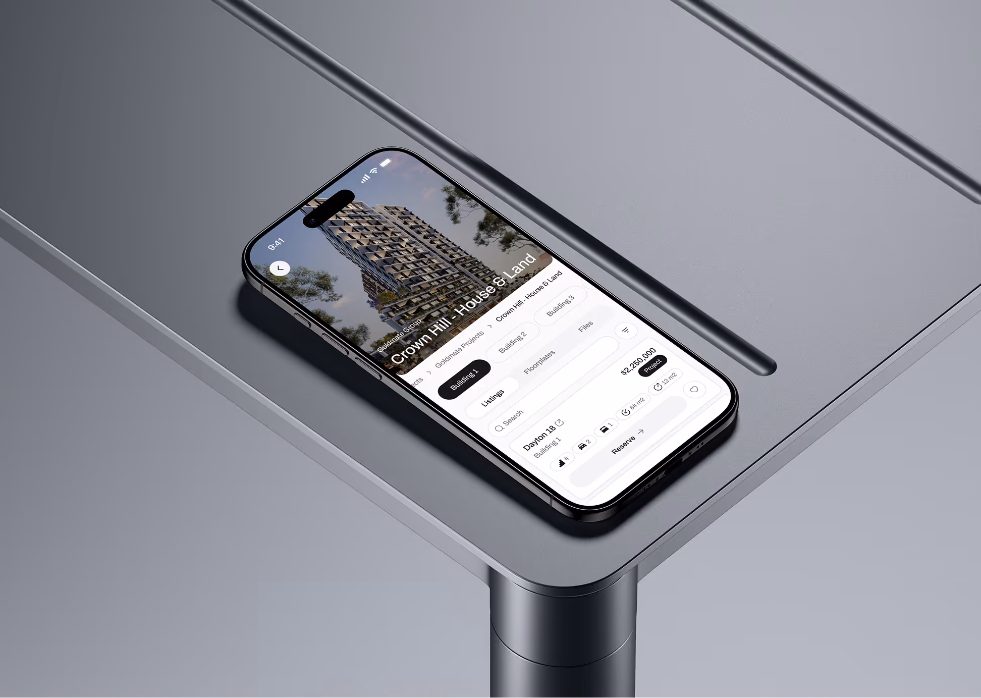 Smartphone displaying a real estate app with property details and a building image on a gray table.