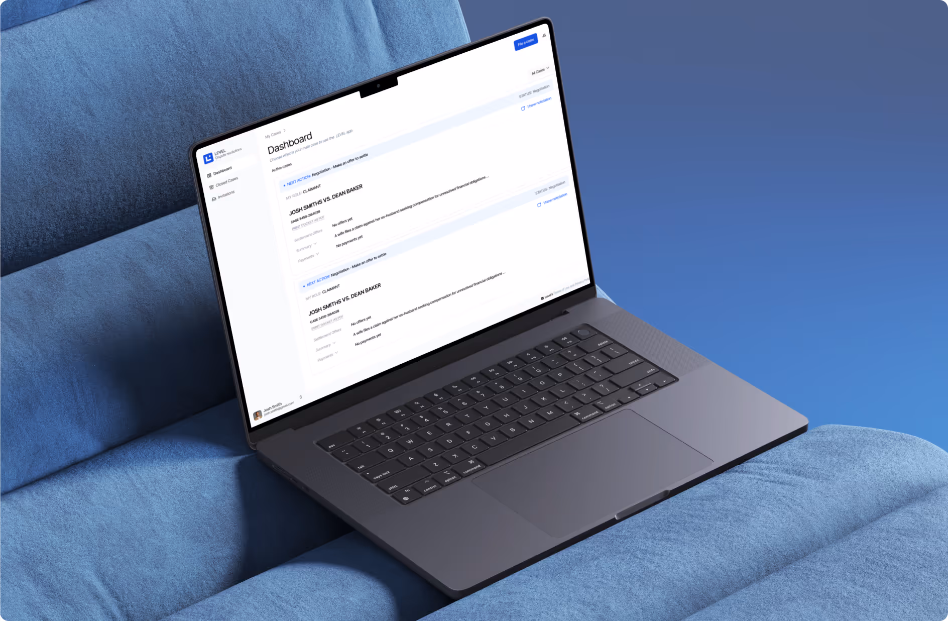 Open laptop showing a legal case dashboard on a blue sofa.