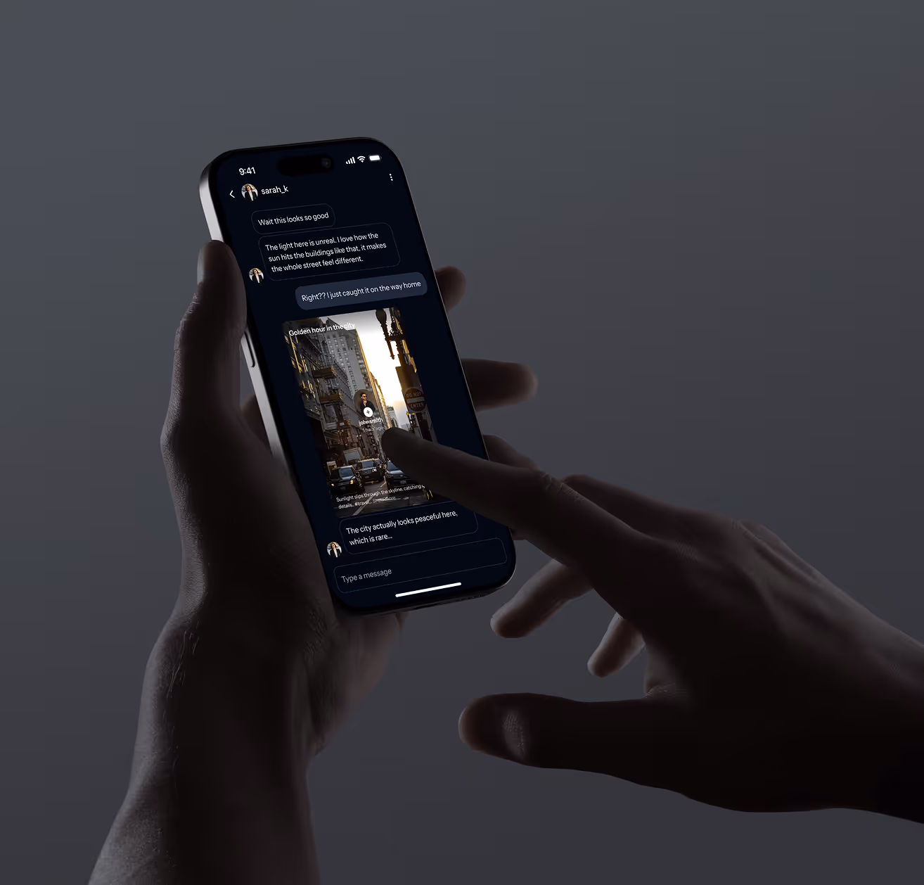 Person holding a smartphone showing a dark-mode chat about city sunlight and a photo of a city street.