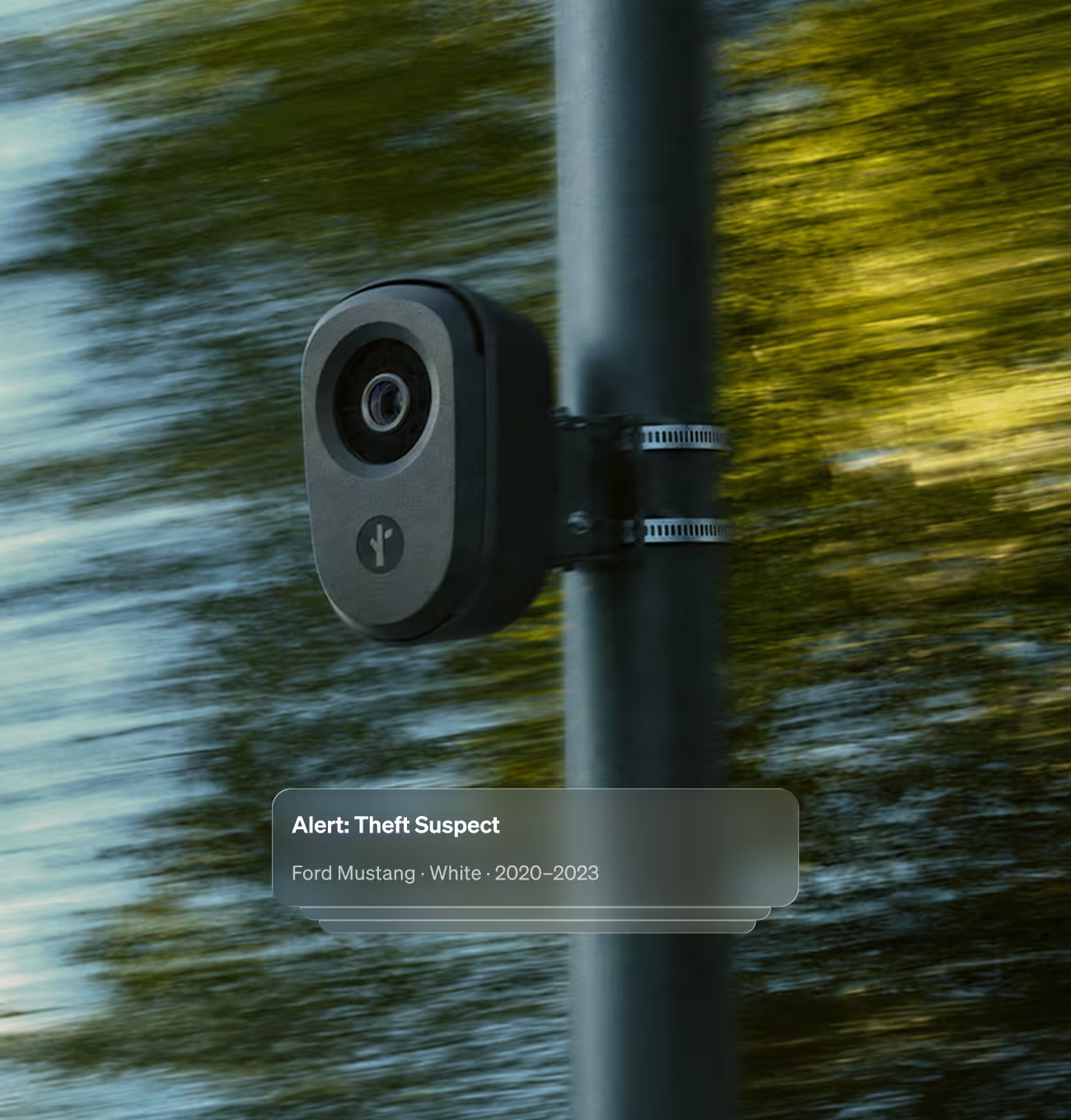 Flock LPR camera on a roadside pole with a hot list alert for a white Ford Mustang