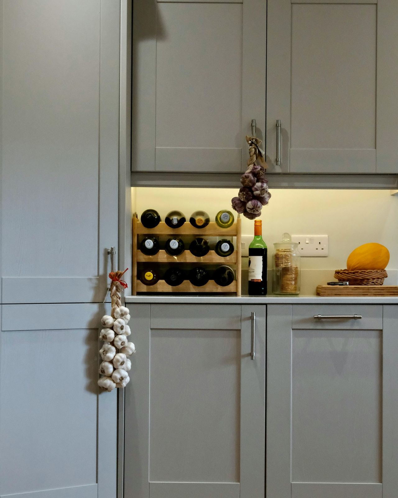 Cozy Kitchen Interior with Wine Rack and Garlic