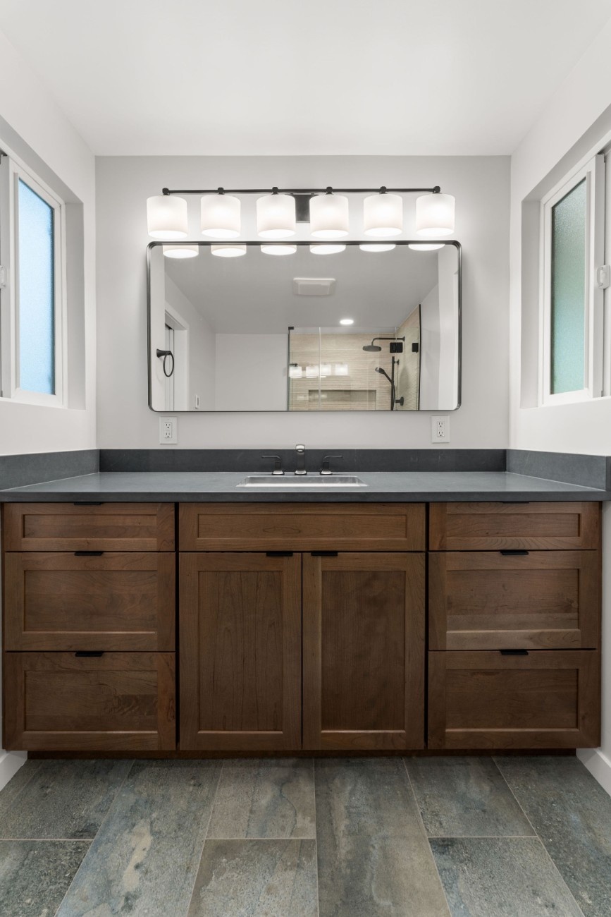 A modern bathroom vanity installed with white lights