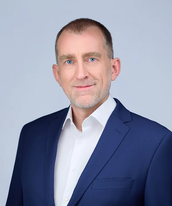 A portrait of Tomasz Buk, DCX CEO
