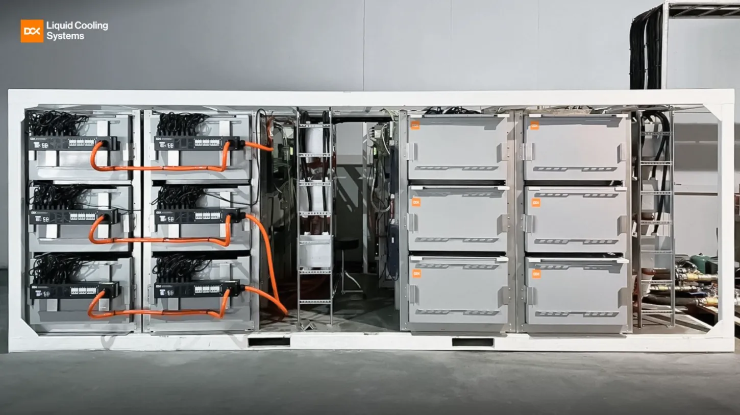 Industrial liquid cooling system with interconnected gray cabinets and orange cables in a white frame.