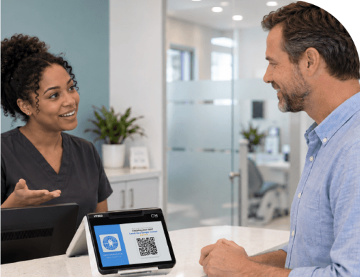 Front desk team member speaking personally with a patient at checkout