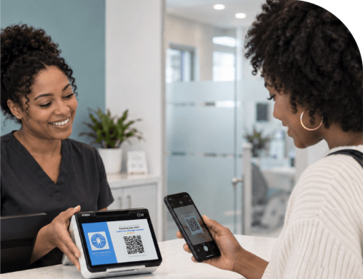 Front desk team member showing another patient the review screen