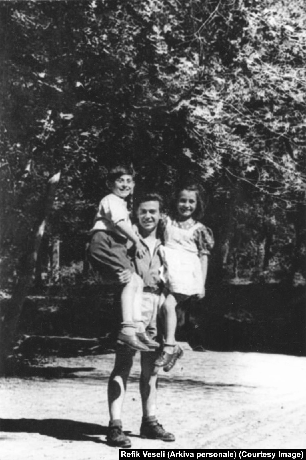 Refik Veseli with two children from the Mandil family during their wartime escape, in a photograph shared by Radio Free Europe/Radio Liberty