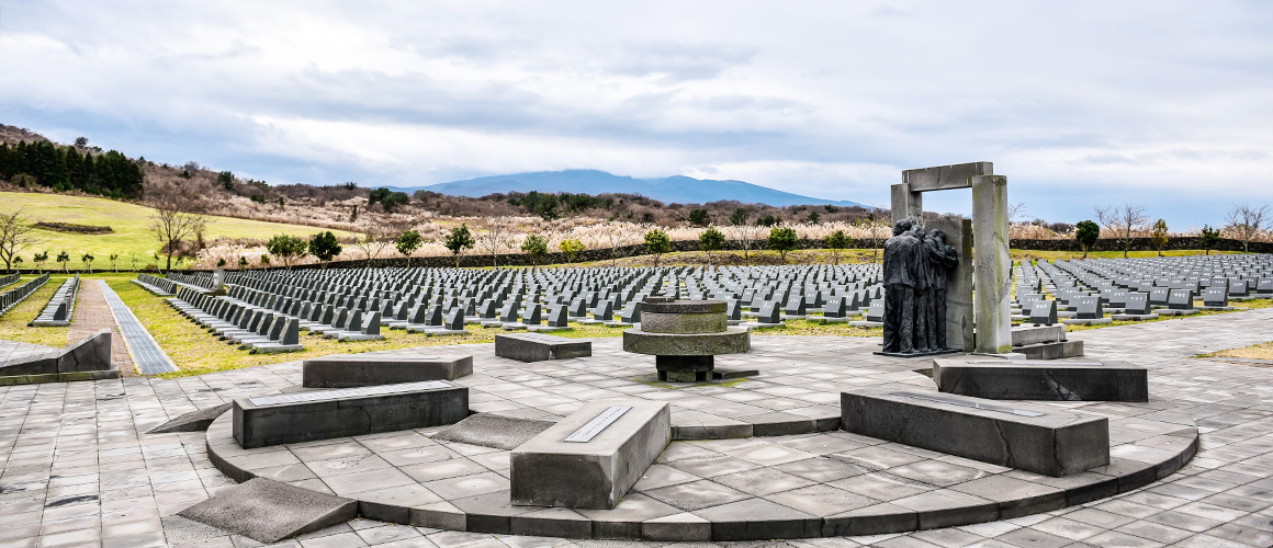 Rows of memorial markers and a sculpture at the Jeju 4·3 Peace Park, via the official Visit Jeju portal
