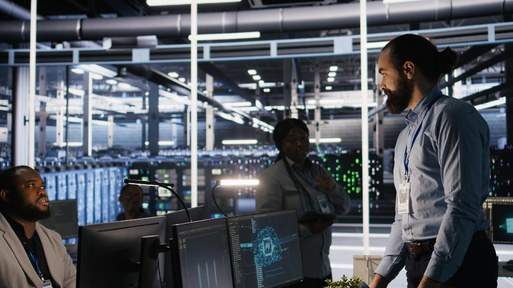People working among data center server racks