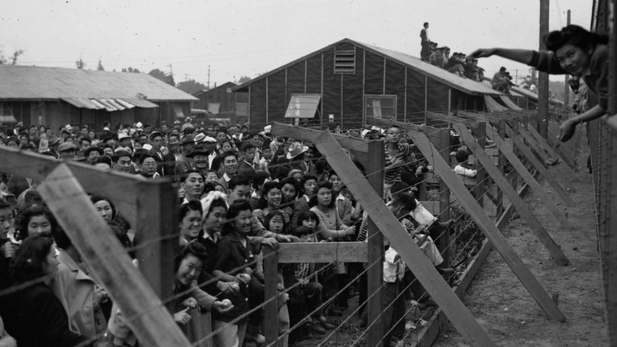 Historical photograph of people at a wartime detention camp