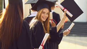 Graduates celebrating in academic gowns