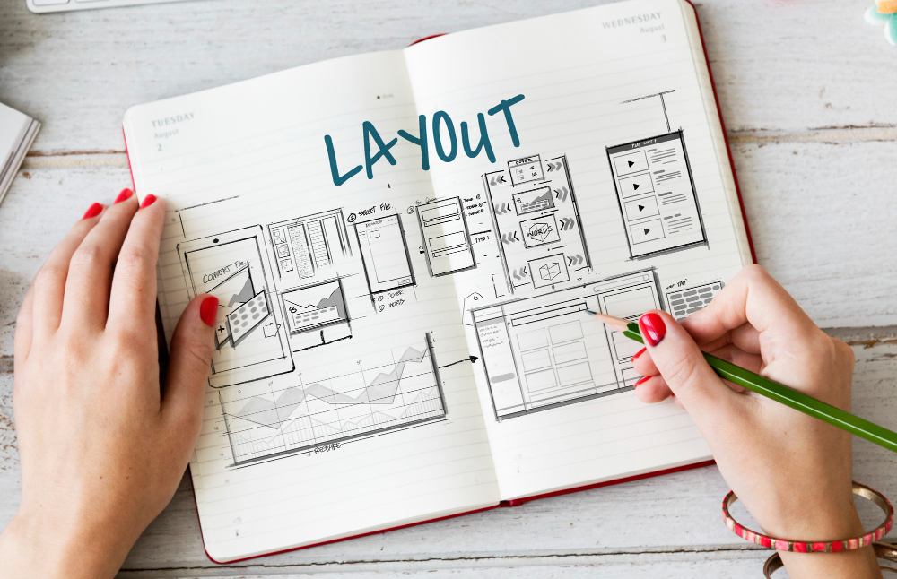 Hands drawing a website layout