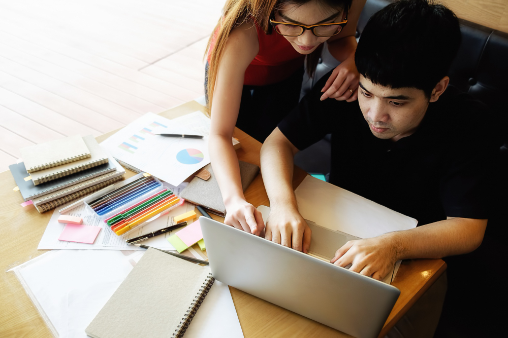 Design students collaborating at a laptop
