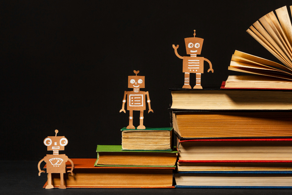 Small robots standing beside a stack of books