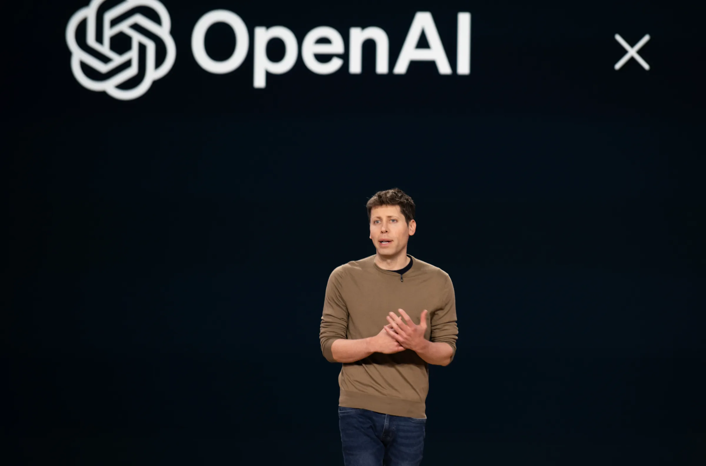 OpenAI presentation with a speaker on stage